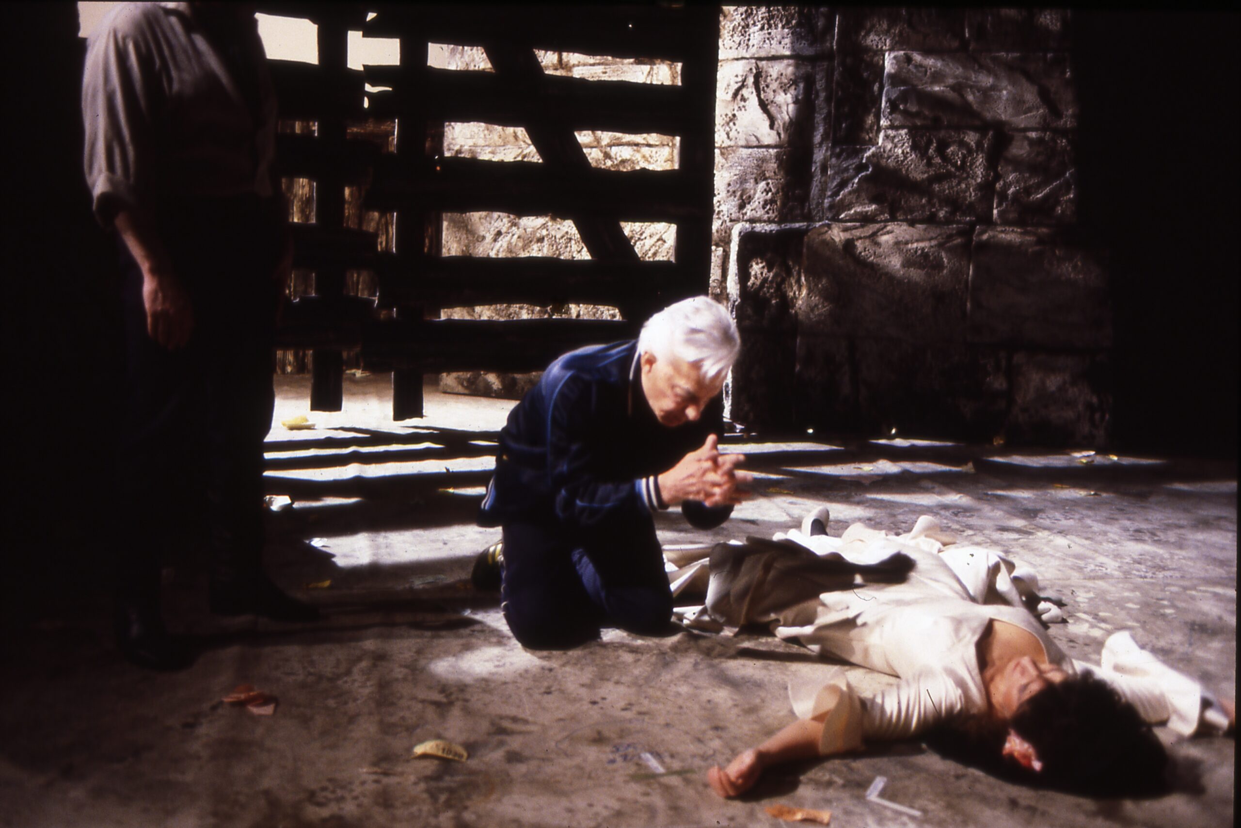 Herbert von Karajan kneeling on the floor while demonstrating the final scene of Carmen to Agnes Baltsa and José Carreras.